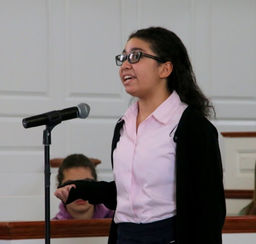 Kristen St. Louis '21 presenting a poem at chapel