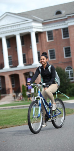 Girl riding bike on campus