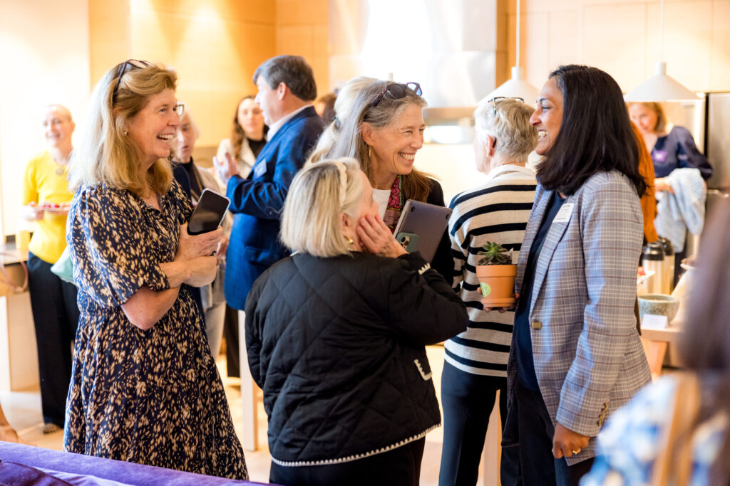 Alumnae Board members and friends of The Ethel Walker School gather in the common space of the new sustainable dorm